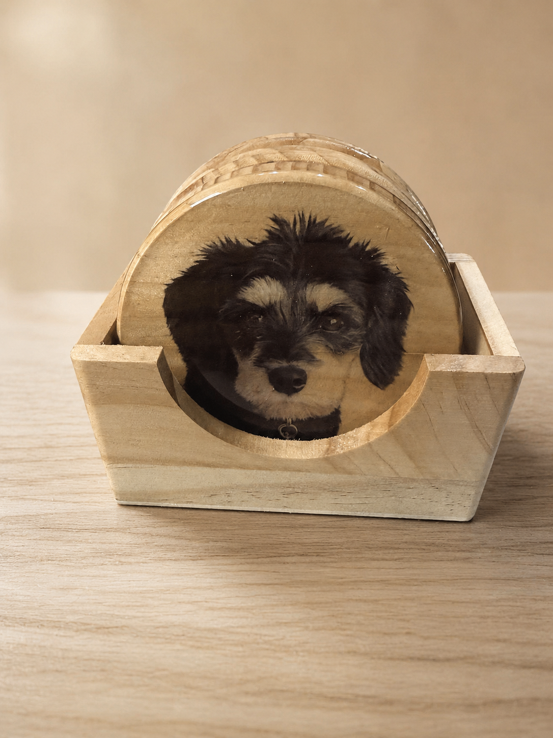 Epoxy-finished pet photo coaster set in a wooden holder on a clean studio background