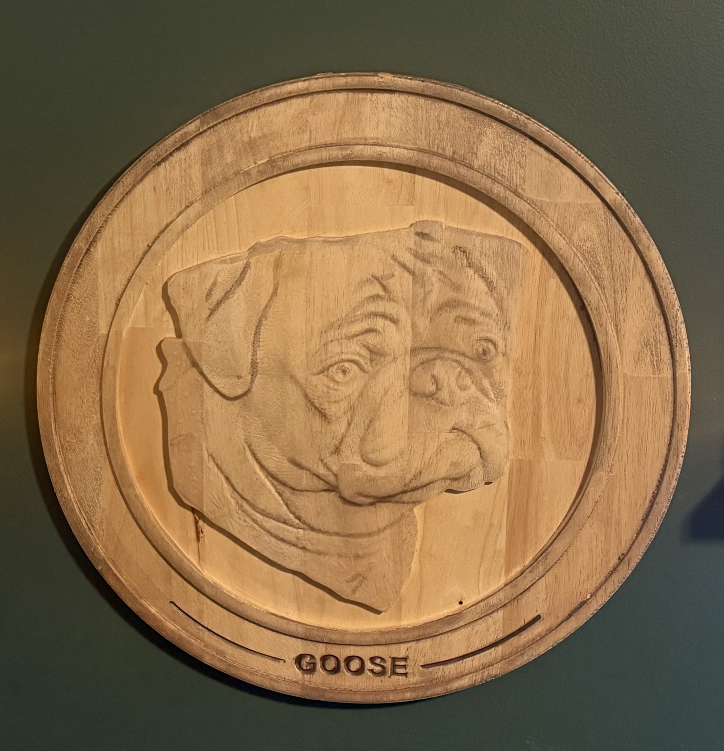 Goose the pug carved as a dimensional wooden relief