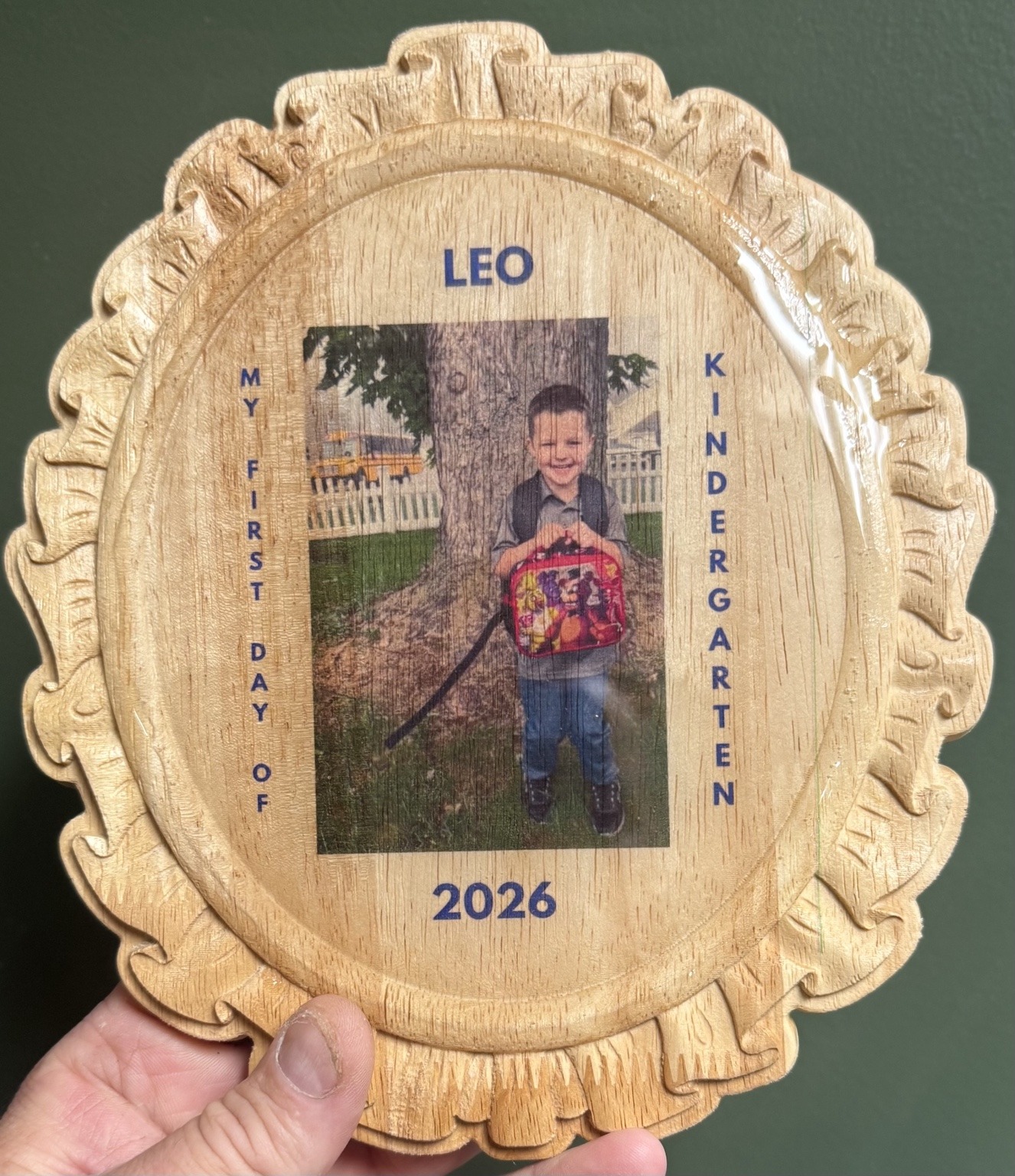 Personalized first day of kindergarten wooden photo frame featuring Leo by the school bus